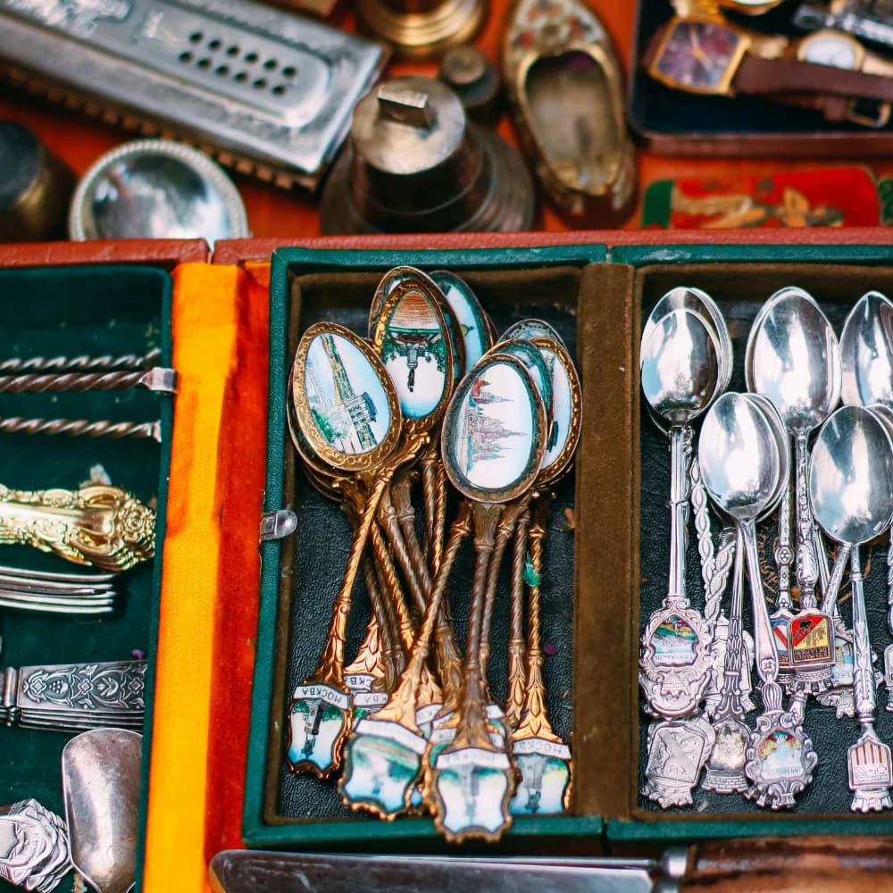 Case of collectible souvenir spoons and other memorabilia