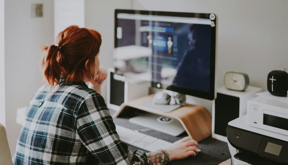 Woman at a desktop computer setting up her online store connection