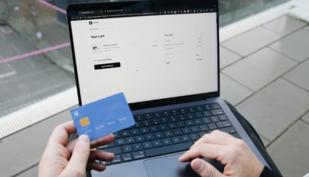 Shopper paying for an online order with a credit card on a laptop