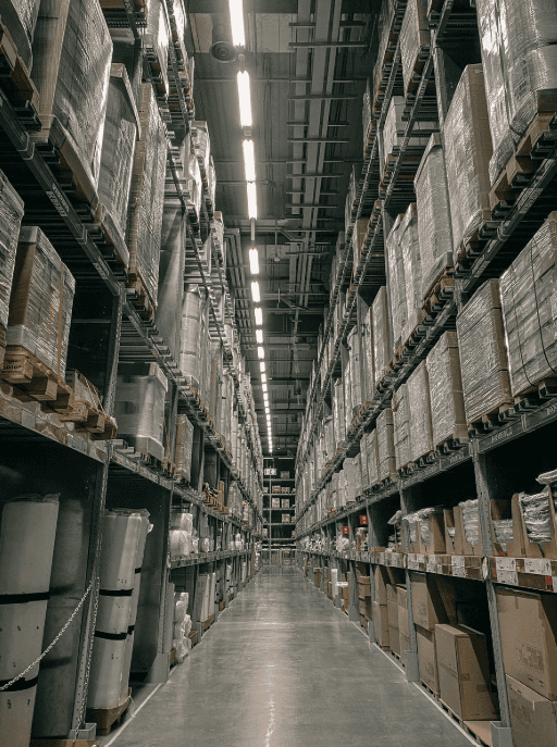 Long warehouse aisle with racking stacked to the ceiling